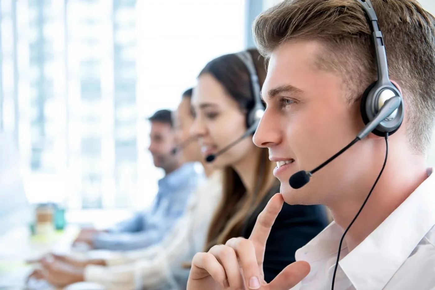 A travel desk team on calls, headsets on, helping travellers