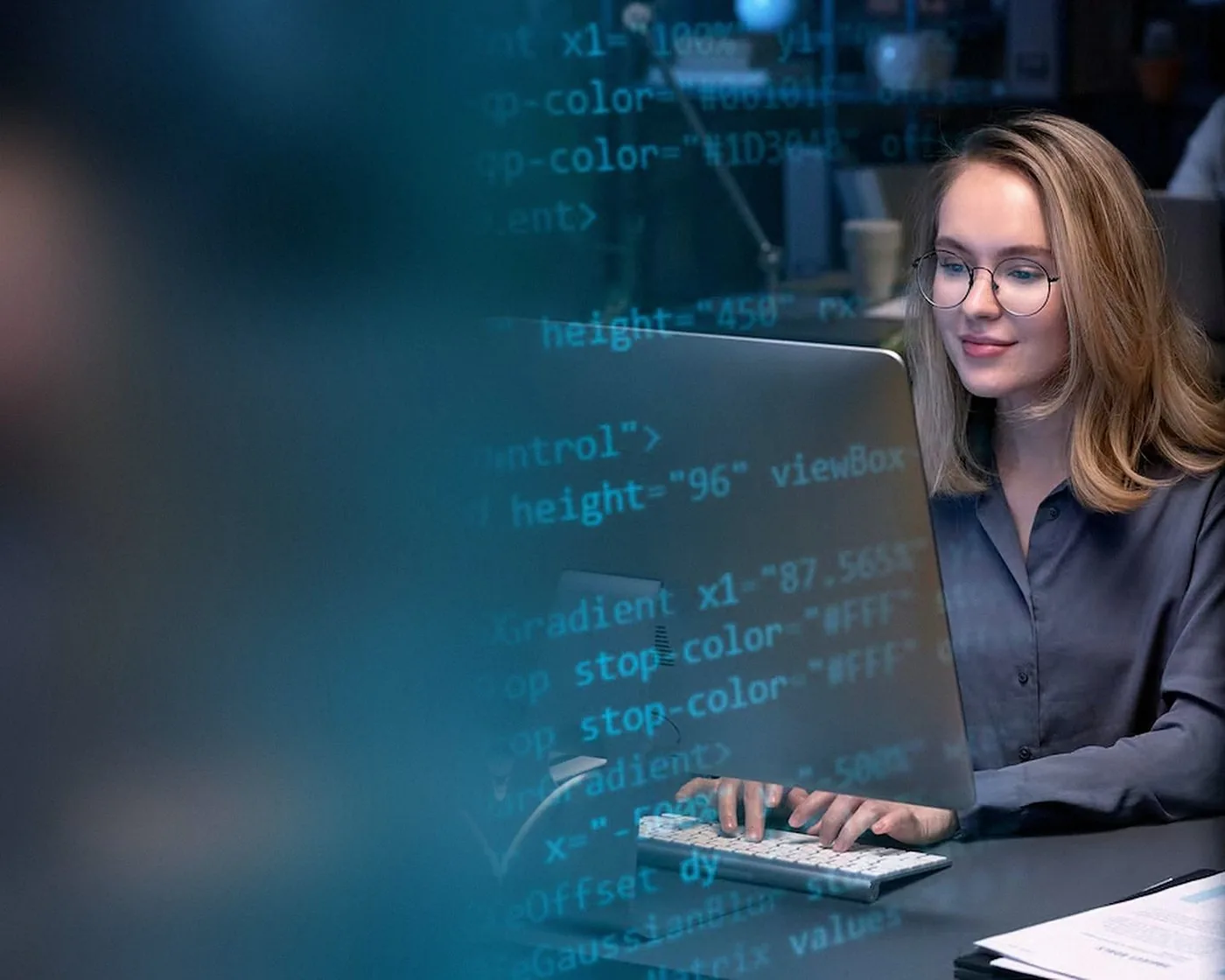 A developer writing code at her desk