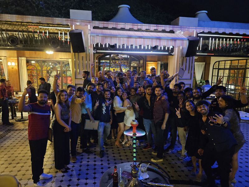 A large group of colleagues gathered at an evening venue