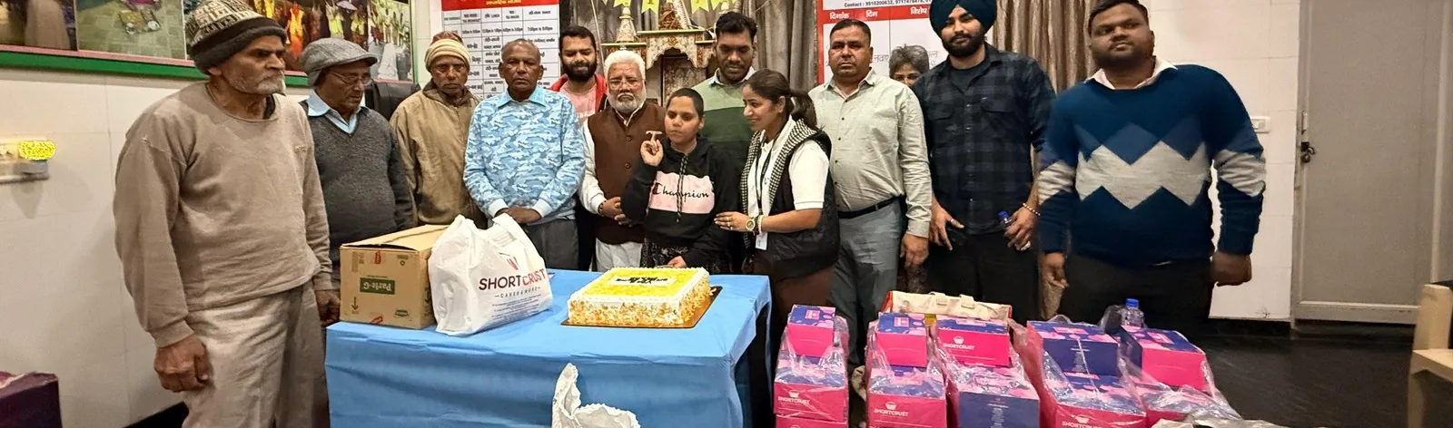 VMS volunteers with elderly residents at the DAVO home, with a birthday cake and gifts