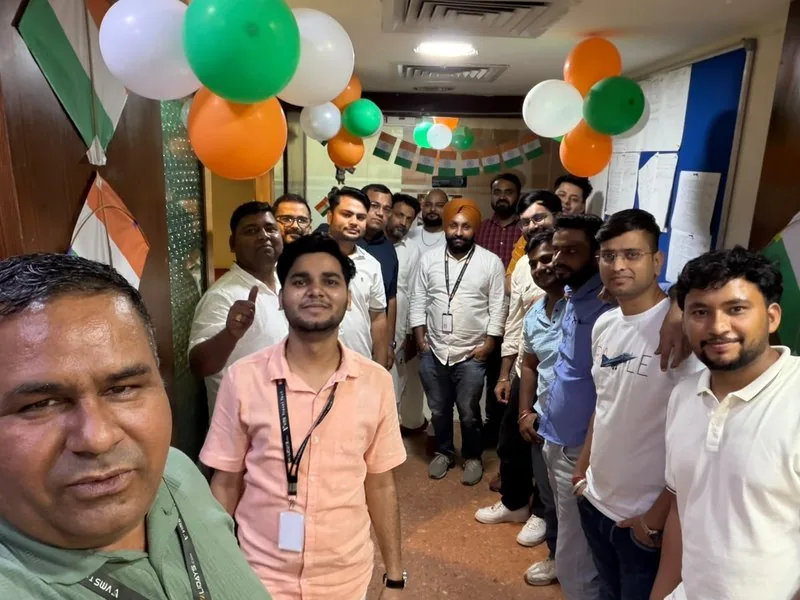 Colleagues celebrating Independence Day in the office, with tricolour balloons and kites
