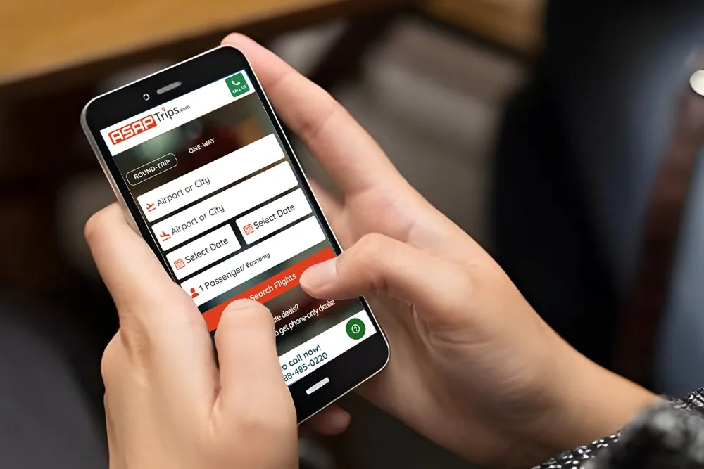 A traveller searching flights on the ASAPTrips booking site on a phone